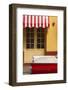 Cuba, Trinidad. Colorful Building and Striped Awning Compliment the Red Color of a Ford Fairlane-Brenda Tharp-Framed Photographic Print