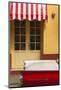 Cuba, Trinidad. Colorful Building and Striped Awning Compliment the Red Color of a Ford Fairlane-Brenda Tharp-Mounted Photographic Print