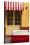 Cuba, Trinidad. Colorful Building and Striped Awning Compliment the Red Color of a Ford Fairlane-Brenda Tharp-Stretched Canvas