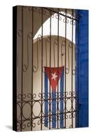 Cuba, Vinales, Cuban flag in courtyard and wrought iron gate.-Merrill Images-Stretched Canvas