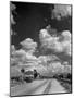 Cumulus Clouds Billowing over Texaco Gas Station along a Stretch of Highway US 66-Andreas Feininger-Mounted Photographic Print