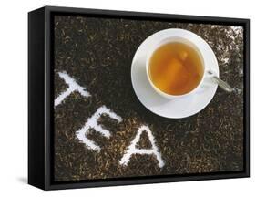 Cup of Black Tea, Surrounded by Tea Leaves with the Word Tea-null-Framed Stretched Canvas