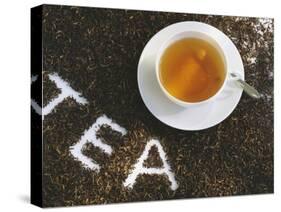 Cup of Black Tea, Surrounded by Tea Leaves with the Word Tea-null-Stretched Canvas