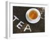 Cup of Black Tea, Surrounded by Tea Leaves with the Word Tea-null-Framed Photographic Print