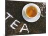 Cup of Black Tea, Surrounded by Tea Leaves with the Word Tea-null-Mounted Photographic Print