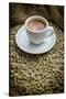 Cup of Espresso on a Sack with Unroasted Coffee Beans-Bernd Wittelsbach-Stretched Canvas