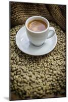 Cup of Espresso on a Sack with Unroasted Coffee Beans-Bernd Wittelsbach-Mounted Photographic Print