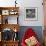 Curious Girl Looking at a Toy Chicken Head Toy by Charles Eames-Allan Grant-Framed Photographic Print displayed on a wall