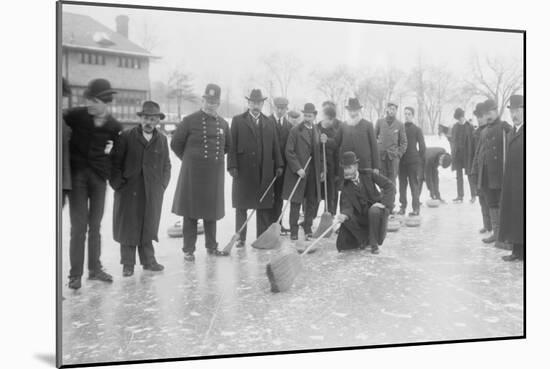 Curling in Central Park with Men Having Brooms at the Ready over the Ice.-null-Mounted Art Print