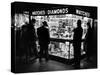 Customers Peering at the Wares Inside a Small, Brightly Lit Times Square Jewelry and Watch Shop-Peter Stackpole-Stretched Canvas