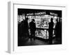 Customers Peering at the Wares Inside a Small, Brightly Lit Times Square Jewelry and Watch Shop-Peter Stackpole-Framed Photographic Print