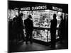 Customers Peering at the Wares Inside a Small, Brightly Lit Times Square Jewelry and Watch Shop-Peter Stackpole-Mounted Photographic Print