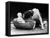 Cute Dog Licking Baby Girl (6-11 Moths) Sitting in Basket-null-Framed Stretched Canvas