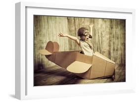 Cute Dreamer Boy Playing with a Cardboard Airplane. Childhood. Fantasy, Imagination. Retro Style.-prometeus-Framed Photographic Print
