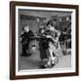 Cute Little Girl Busily at Work, Sitting in a Desk Chair in a Schoolroom, Other Pupils at Work Too-Gordon Parks-Framed Photographic Print