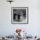 Cute Little Girl Busily at Work, Sitting in a Desk Chair in a Schoolroom, Other Pupils at Work Too-Gordon Parks-Framed Photographic Print displayed on a wall