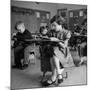 Cute Little Girl Busily at Work, Sitting in a Desk Chair in a Schoolroom, Other Pupils at Work Too-Gordon Parks-Mounted Photographic Print