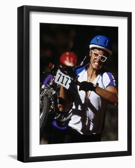 Cyclist Carrying His Mountain Bike During a Race-null-Framed Photographic Print