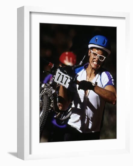 Cyclist Carrying His Mountain Bike During a Race-null-Framed Photographic Print