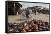 Cyclist Passing a Stall Selling Traditional Clay Tajine Cooking Pots in Place Jemaa El-Fna-Martin Child-Framed Stretched Canvas