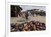 Cyclist Passing a Stall Selling Traditional Clay Tajine Cooking Pots in Place Jemaa El-Fna-Martin Child-Framed Photographic Print