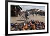 Cyclist Passing a Stall Selling Traditional Clay Tajine Cooking Pots in Place Jemaa El-Fna-Martin Child-Framed Photographic Print