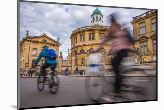 Cyclists Passing the Sheldonian Theatre, Oxford, Oxfordshire, England, United Kingdom, Europe-John Alexander-Mounted Photographic Print
