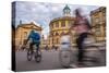 Cyclists Passing the Sheldonian Theatre, Oxford, Oxfordshire, England, United Kingdom, Europe-John Alexander-Stretched Canvas