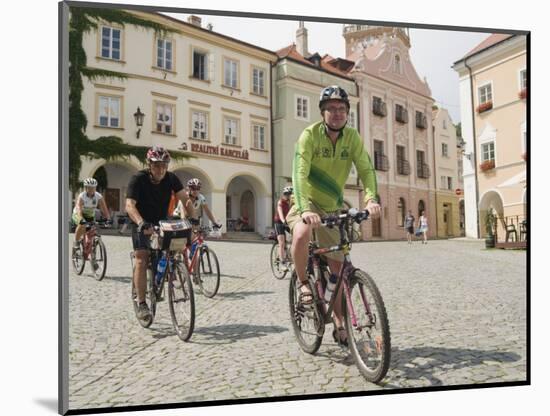 Cyclists Riding Through Namesti in Town of Mikulov, Brnensko Region-Richard Nebesky-Mounted Photographic Print