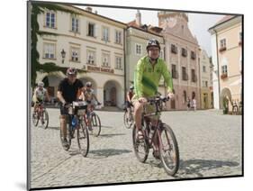 Cyclists Riding Through Namesti in Town of Mikulov, Brnensko Region-Richard Nebesky-Mounted Photographic Print