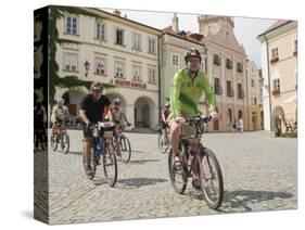 Cyclists Riding Through Namesti in Town of Mikulov, Brnensko Region-Richard Nebesky-Stretched Canvas