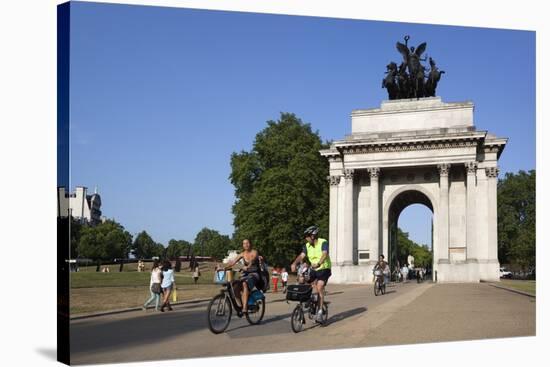 Cyclists under the Wellington Arch, Hyde Park Corner, London, England, United Kingdom, Europe-Stuart Black-Stretched Canvas