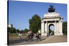 Cyclists under the Wellington Arch, Hyde Park Corner, London, England, United Kingdom, Europe-Stuart Black-Stretched Canvas