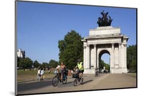 Cyclists under the Wellington Arch, Hyde Park Corner, London, England, United Kingdom, Europe-Stuart Black-Mounted Photographic Print