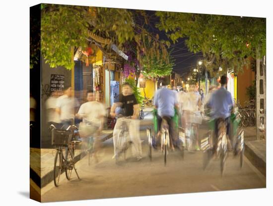 Cyclos and Bicycles on Street at Dusk, Hoi An, Quang Nam, Vietnam, Indochina, Southeast Asia, Asia-Ian Trower-Stretched Canvas