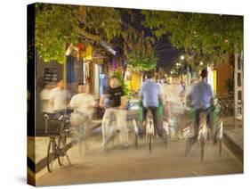 Cyclos and Bicycles on Street at Dusk, Hoi An, Quang Nam, Vietnam, Indochina, Southeast Asia, Asia-Ian Trower-Stretched Canvas