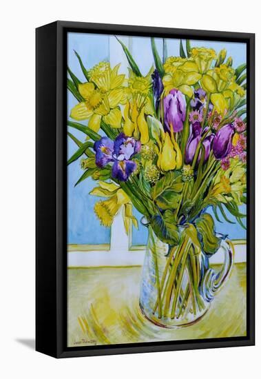 Daffodils and tulips in a glass jug by a window-Joan Thewsey-Framed Stretched Canvas