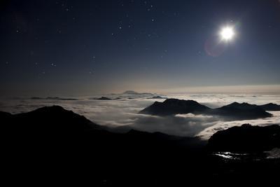 Moon Sand Stars Shine Above Low Lying Clouds on Mount Rainier National Park