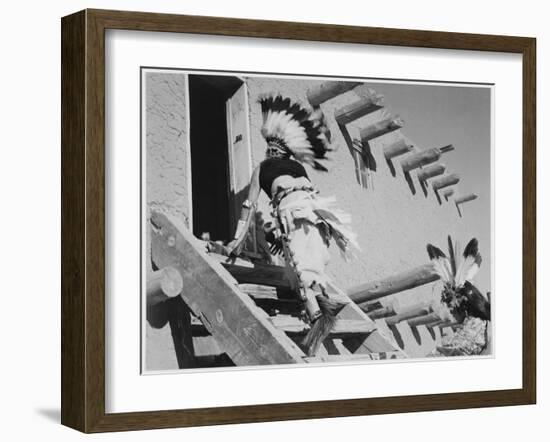 Dance San Ildefonso Pueblo New Mexico 1942 Two Indians In Headdress Ascending Stairs To House 1942-Ansel Adams-Framed Art Print