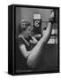 Dancer Mary Ellen Terry Talking with Her Legs Up in Telephone Booth-Gordon Parks-Framed Stretched Canvas