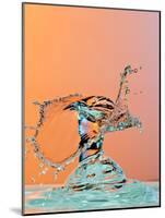 Dancing Water Droplet High Speed Photography on an Orange Background-Circumnavigation-Mounted Photographic Print