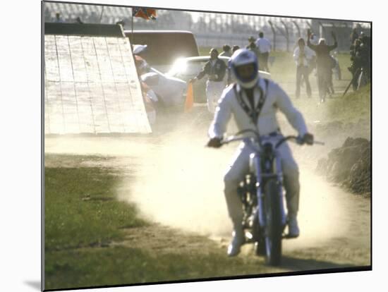 Daredevil Motorcyclist Evel Knievel Raising Dust after Completing Stunt-null-Mounted Photographic Print