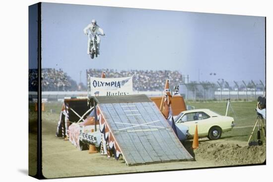 Daredevil Motorcyclist Evel Knievel Rising Very High Off Platform During Performance of a Stunt-Bill Eppridge-Stretched Canvas