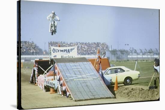 Daredevil Motorcyclist Evel Knievel Rising Very High Off Platform During Performance of a Stunt-Bill Eppridge-Stretched Canvas