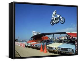 Daredevil Motorcyclist Evil Knievel in Mid Jump over a Row of Cars-Ralph Crane-Framed Stretched Canvas