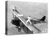 Daredevils Playing Tennis on a Biplane-null-Stretched Canvas
