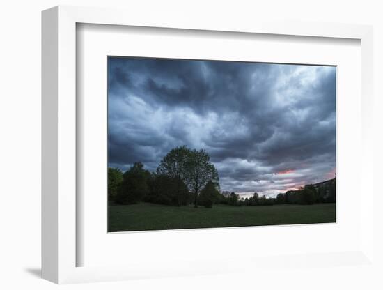 Dark clouds above a park-Benjamin Engler-Framed Photographic Print