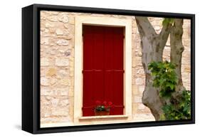 Dark red shutters in the wall of a house in France.-Tom Haseltine-Framed Stretched Canvas