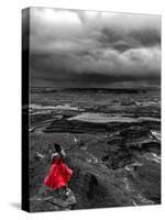 Dark storm clouds over Dead Horse Point State Park with girl in red dress standing near the cliff-David Chang-Stretched Canvas