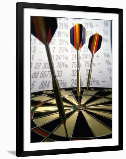 Darts on a Dartboard with Stock Figures in the Background-null-Framed Premium Photographic Print